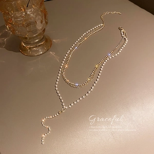 Elegant layered gold Y-necklace with pearls and sparkling rhinestones for women