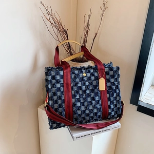 Large denim tote bag with navy checkerboard pattern and wine red straps in casual style