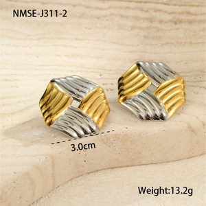 Detail of gold and silver hex earrings with vertical textured stripes and dimensions