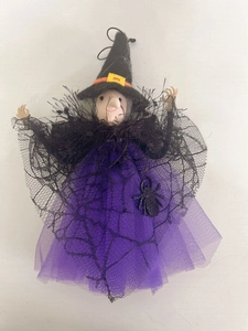 Detailed view of Halloween witch doll with purple mesh skirt and black spider pendant