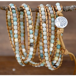 Detail of bohemian five-layer wrap bracelet with natural stone beads and tree of life button