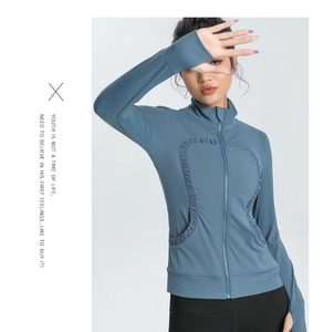 Detail of blue slim-fit sports jacket with U-shaped pleats and thumbhole cuffs