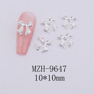 Detailed view of silver bow nail art charms with irregular texture and 10x10mm size
