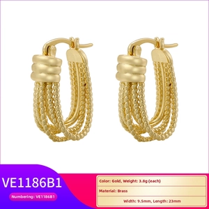 Detail of gold brass U-shaped twisted hoop earrings with 9.5mm width and 23mm length