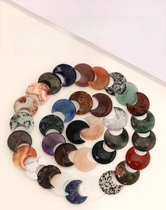 Spiral arrangement of assorted natural moon-shaped gemstones and crystal charms