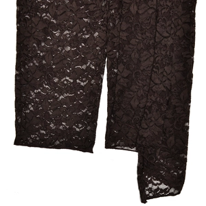 Macro shot of dark brown lace fabric with detailed floral patterns and cut-out texture