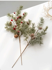 Detail of decorative Christmas pine branches with red berries, pine cones and small bells