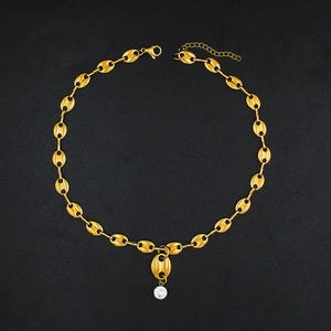 Close-up of golden coffee bean chain link necklace with a sparkling zircon pendant