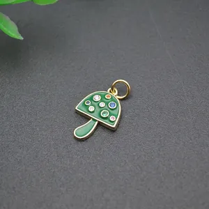 Macro detail of mushroom pendant with 18K gold plating, green enamel and colorful zircons