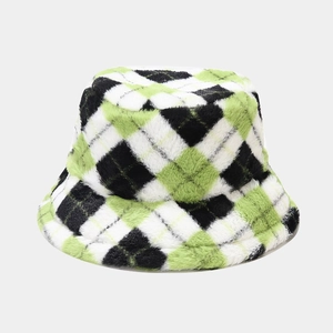 Detail of plush checkered bucket hat in green, black and white faux fur texture