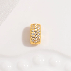 Macro detail of gold plated spacer bead with micro-pave white zircon stones for jewelry DIY