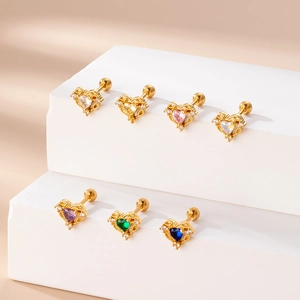 Set of 7 gold heart studs with colorful zircons and secure screw backings on display