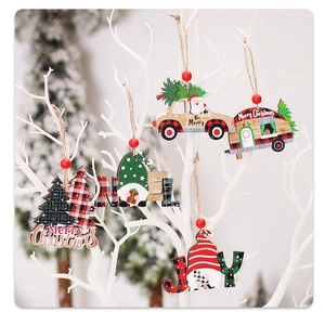 Detail of wooden Christmas ornaments with Santa motifs hanging on white branches