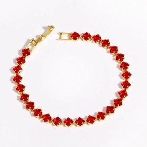 Macro shot of 18k gold plated spacer beads featuring red square-cut zircon stones