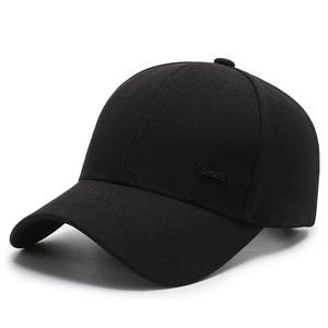 Classic black cotton baseball cap with sport metal label on plain white background
