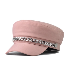 Detailed macro view of pink beret cap featuring rhinestone silver chain and metal buttons