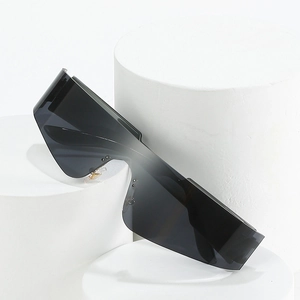 Futuristic frameless black wraparound sports sunglasses on white geometric pedestal