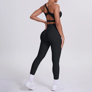 Detail of black sports bra with cross-back cut and high-waisted yoga leggings