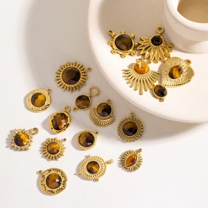 Collection of golden tiger eye stone pendants in various geometric and solar designs