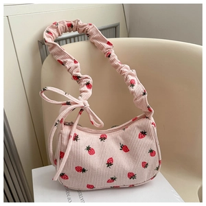 Pink corduroy underarm bag with strawberry print and bow detail on ruffled strap