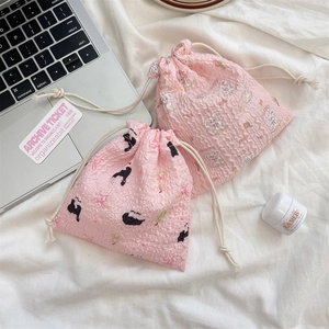 Detail view of pink bubble texture drawstring bags with cute rabbit and puppy prints