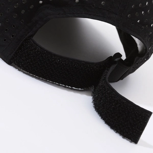 Black quick-dry sports cap with breathable laser-cut holes and adjustable velcro strap