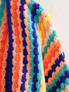 Close-up of multicolored stripe crochet texture and knit patterns on a women sweater