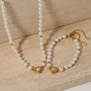 Minimalist stainless steel jewelry set with white pearls and golden heart charms