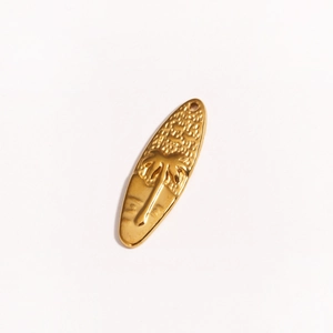 Detailed close-up of a gold surfboard pendant with embossed palm tree design on white background