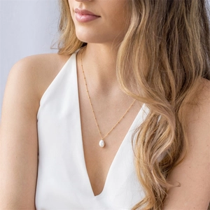 Minimalist freshwater baroque pearl necklace with 14K gold plated chain worn by model