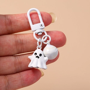 Cute white ghost keychain with matching bell charm on minimalist white metal ring holder