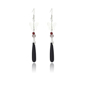 Detail of elegant butterfly drop earrings with pearls and tassels on white background