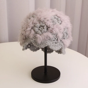 Winter handmade crochet wool hat in grey with fluffy fur trim and floral knit texture