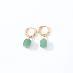 Detailed macro view of geometric light green natural stone pendant earrings with gold hoops