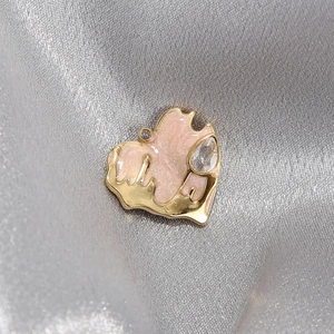 Gold stainless steel heart pendant with pink enamel and sparkling crystal on silk
