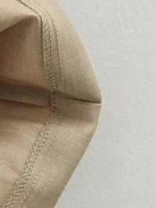 Close-up of high-quality stitching and khaki twill fabric texture on the fashion dress