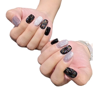 Cat eye press-on nails featuring black base with colorful firework patterns and silver glitter