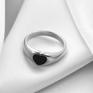 Macro view of minimalist 18K gold stainless steel ring with black shell heart inlay