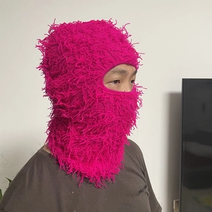 Detail of rose red fuzzy balaclava mask showing rich knit texture on female model