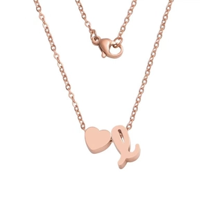Macro shot of rose gold heart pendant with letter L charm and lobster clasp detail