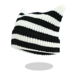 Detailed knit texture of black and white striped beanie with cute cat ear design