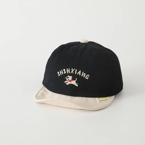 Detail of baby baseball cap featuring cartoon dog embroidery and soft contrast brim