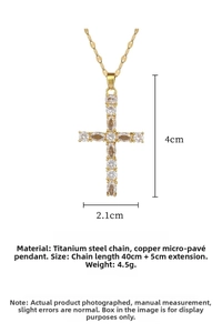 Detail view of gold cross pendant with cubic zirconia stones and measurements