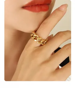 Close-up of chunky gold chain link ring on model with elegant minimalist style
