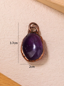 Detailed view of oval purple gemstone pendant in bronze frame with dimensions 3.7x2cm
