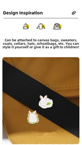 Detail of cute white rabbit enamel pins on canvas bag showing craft and texture