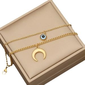 Double-layered gold stainless steel necklace featuring crescent moon and evil eye pendants