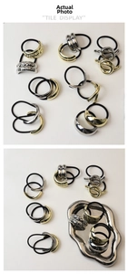 Detail of high-elastic black hair ties with minimalist gold and silver alloy accents