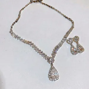 Sparkling silver-toned pear-shaped necklace and earrings set with detailed pavé crystals