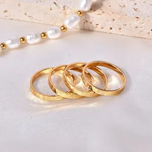 Set of four thin 18k gold-plated stainless steel rings with detailed sunburst engraving